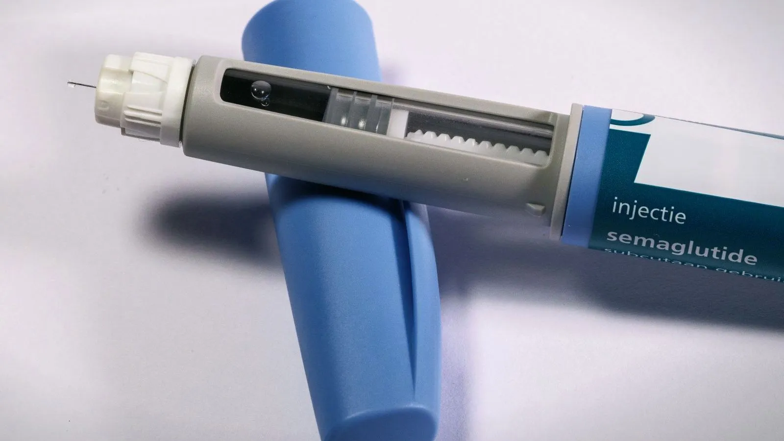 A semaglutide injection pen resting on a surface