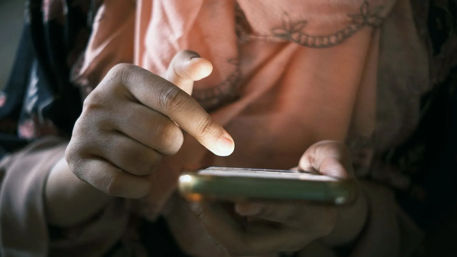 Close-up of two hands holding and scrolling a smartphone