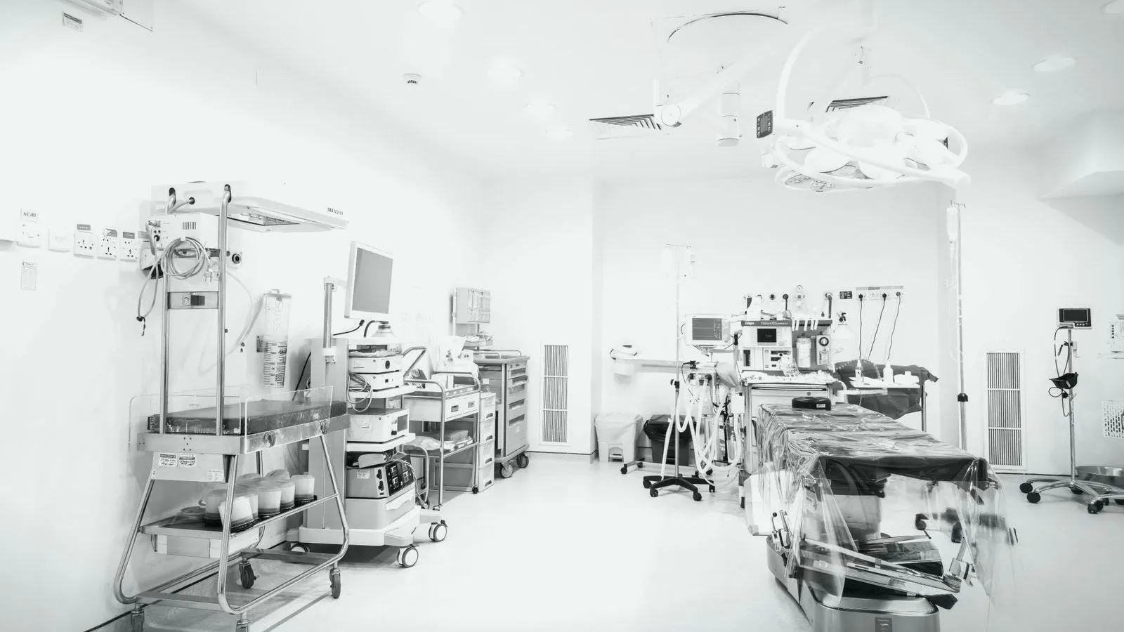 An empty operating theatre with surgical lights and equipment